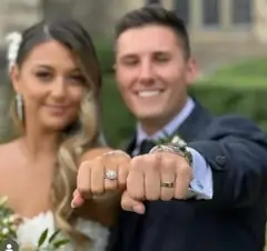 Engaged couple displaying their rings