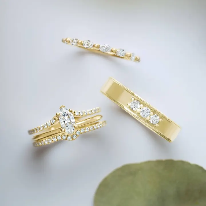 A curated arrangement of diamond rings in yellow gold